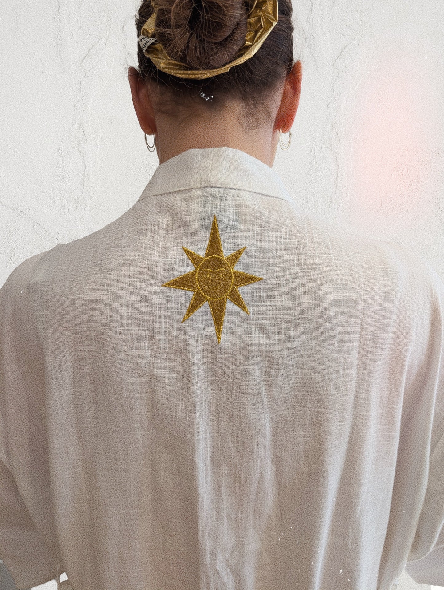 White embroidered gold wrap gown