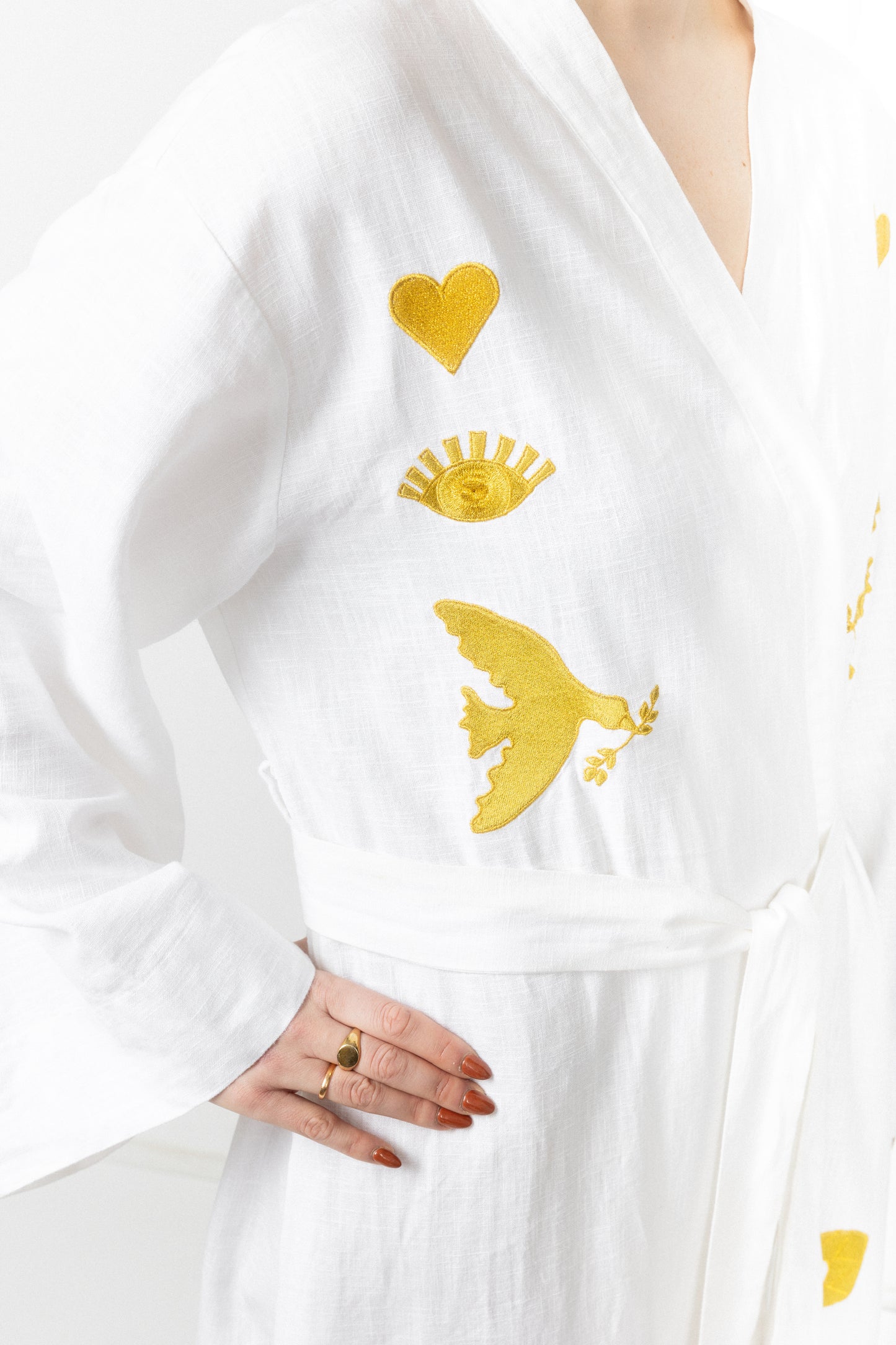 White embroidered gold wrap gown